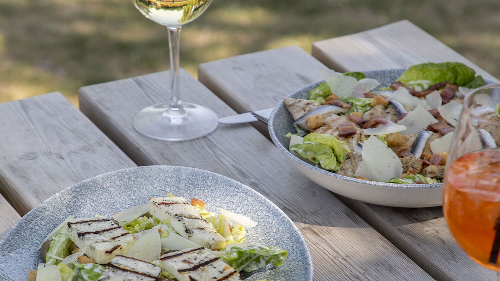 Halloumi Caesar salad with a glass of wine